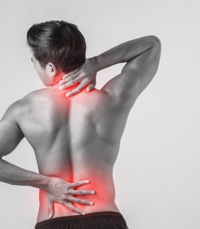 Close up of man rubbing his painful back isolated on white background.