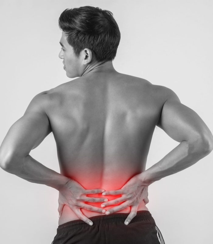 Close up of man rubbing his painful back isolated on white background.