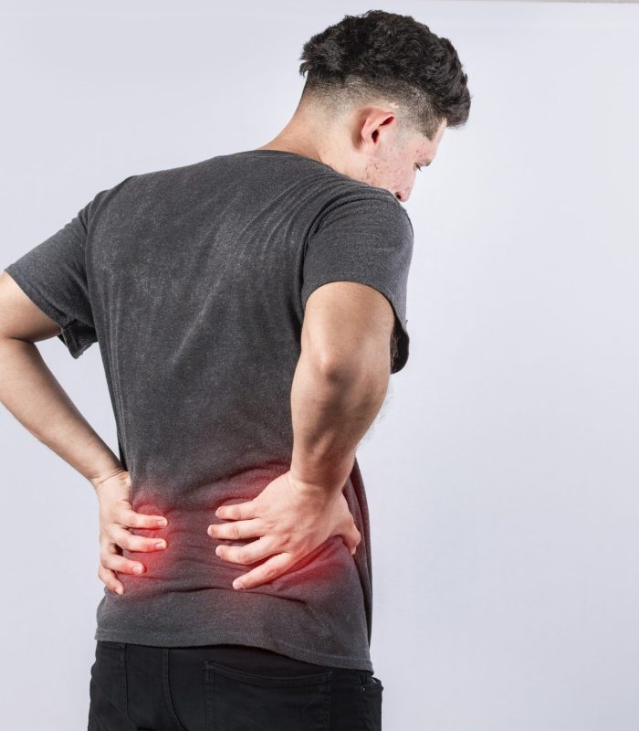 Man with spine problems, person with back problems on isolated background, lumbar problems concept, a sore man with back pain